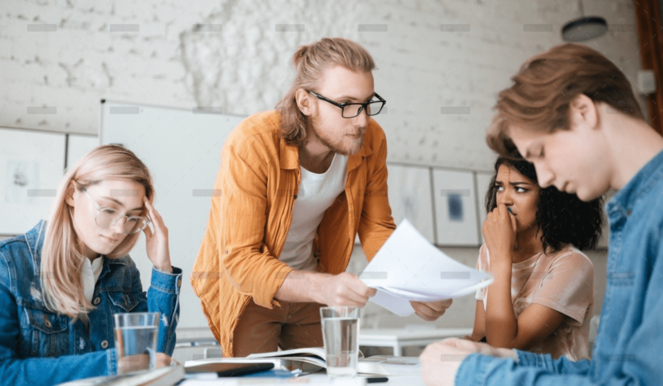 demo-attachment-292-group-of-upset-students-sitting-at-the-table-with-E5YW9L4